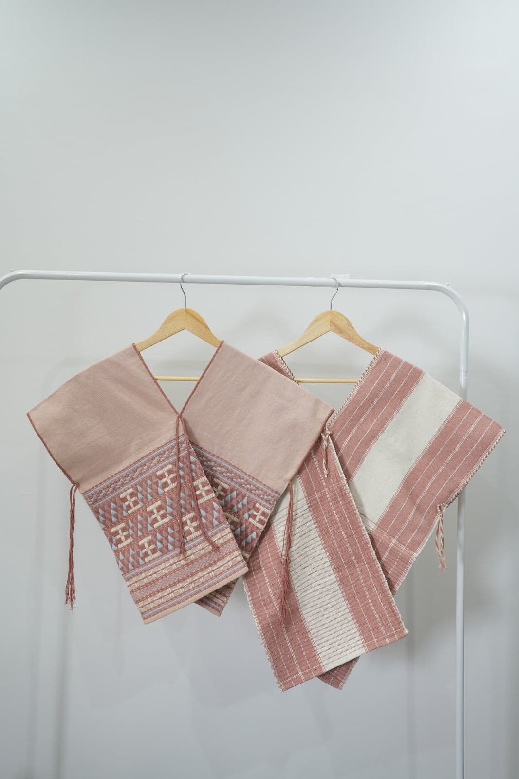 Dusty rose blazers on clothing rack