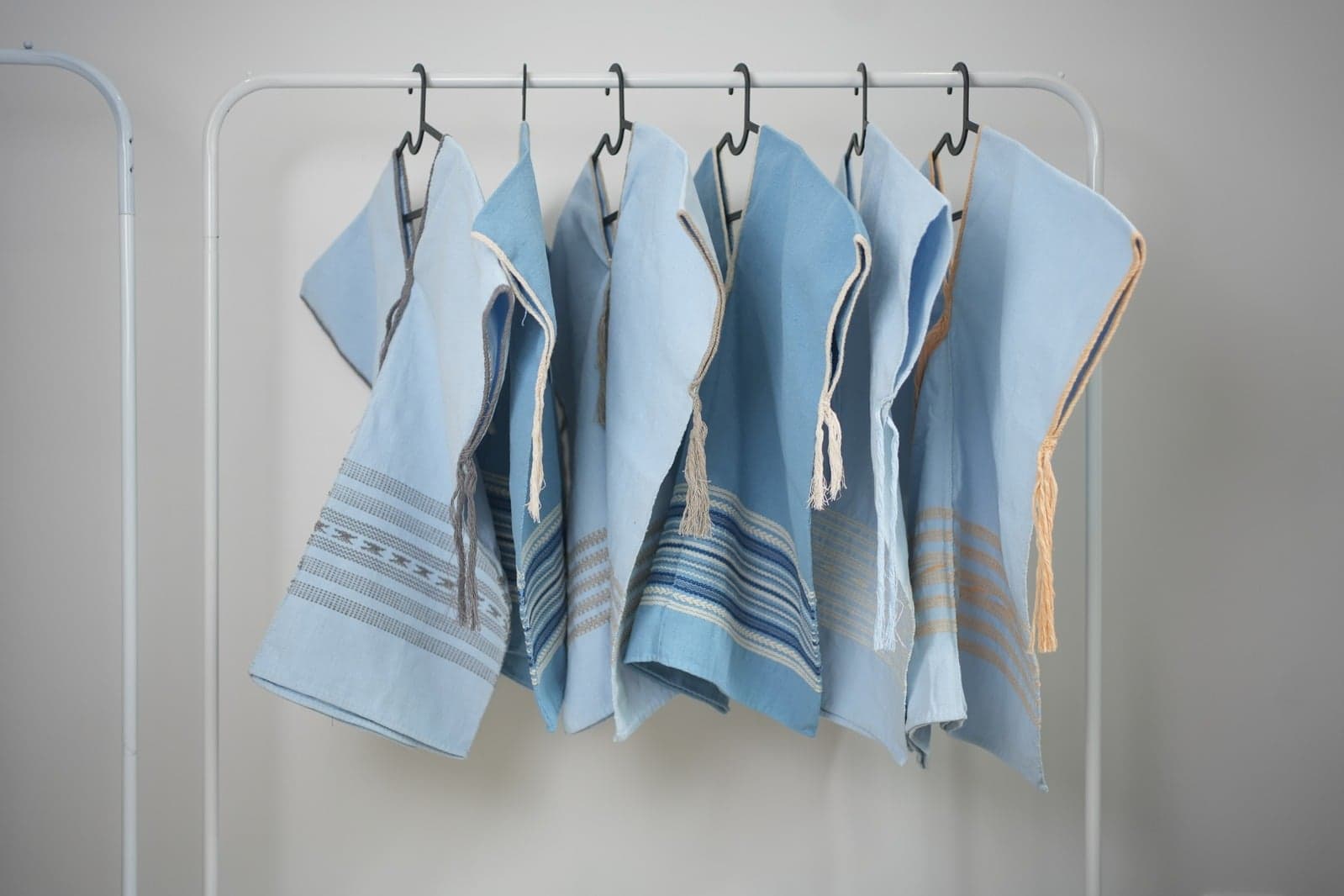Blue cashmere knit garments on rack